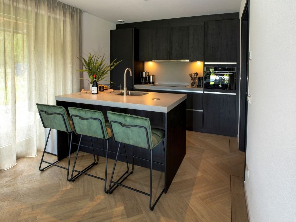Design keuken met groene barkrukken